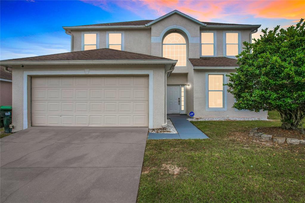 a front view of a house with a yard