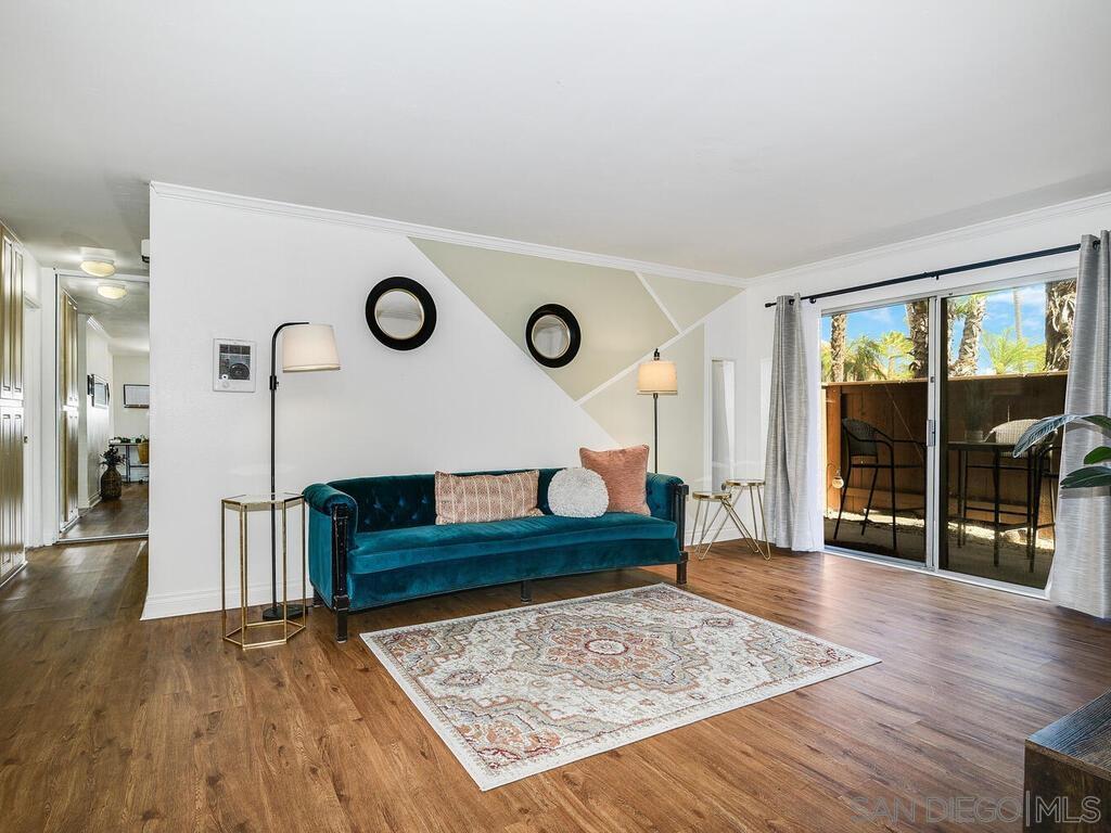 a living room with couch and wooden floor