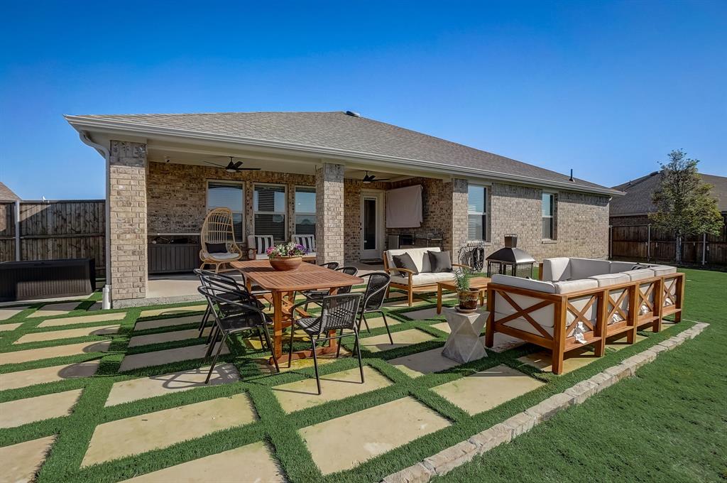 a view of a house with backyard and sitting area