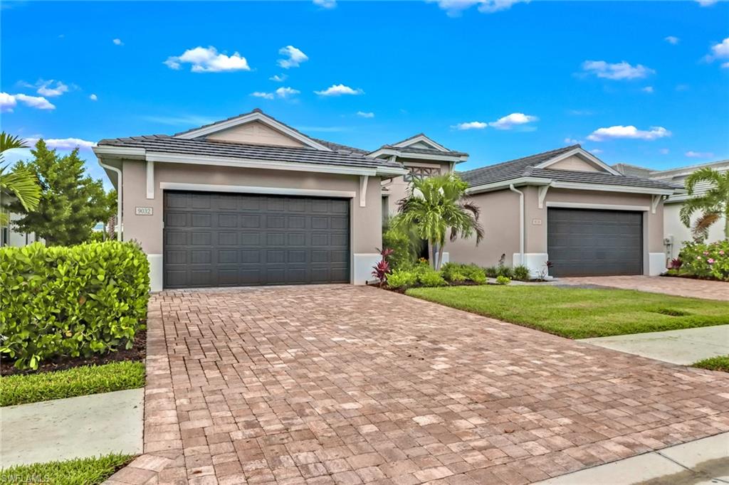 a front view of a house with a yard and garage