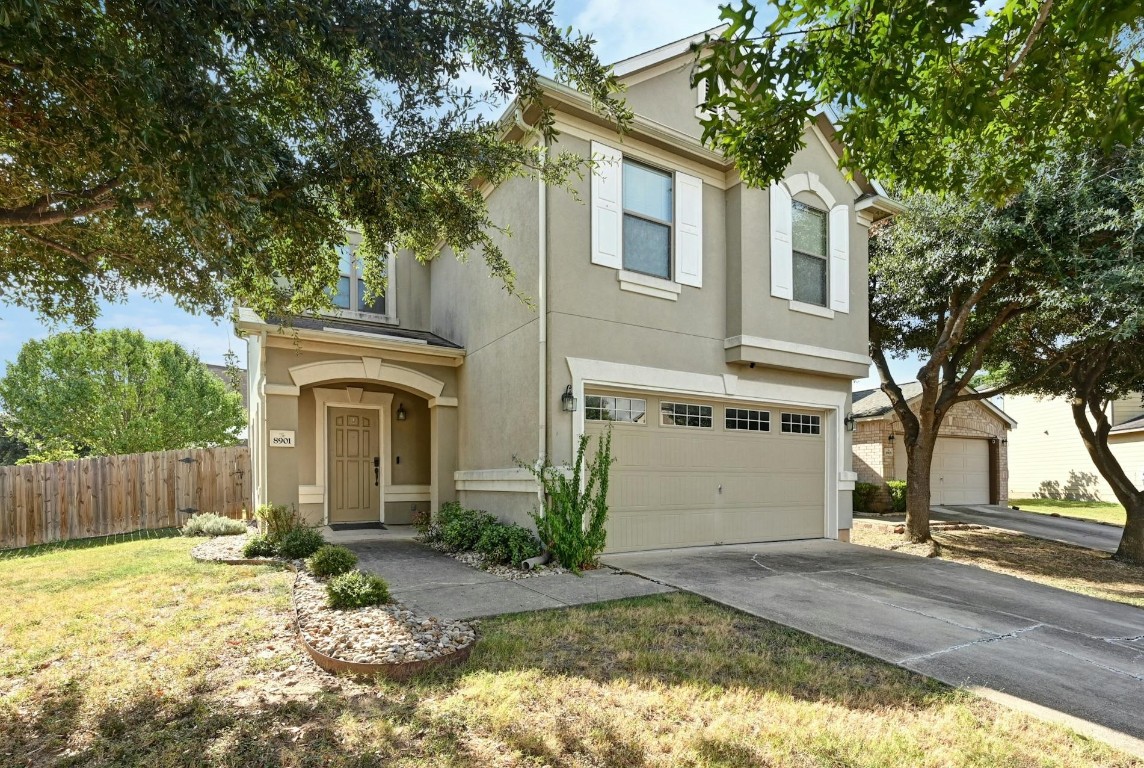 a front view of a house with a yard and garage