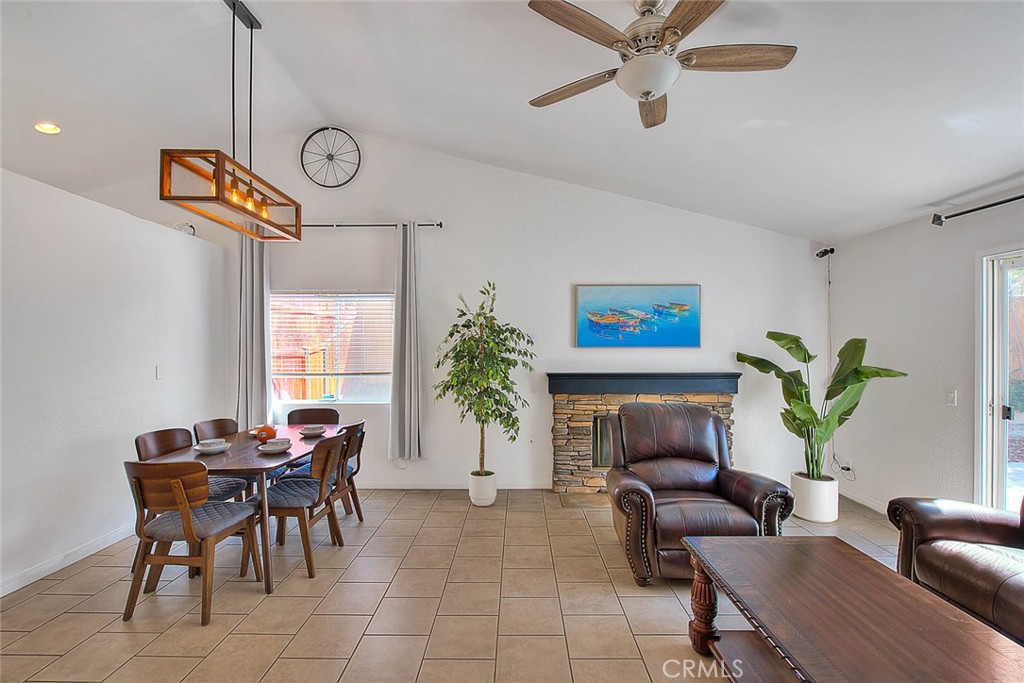 a living room with furniture a fireplace and a table