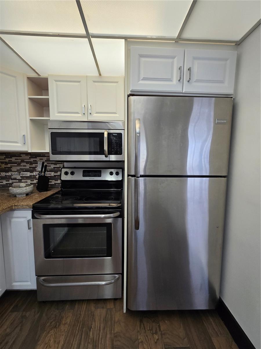 a kitchen with appliances and cabinets