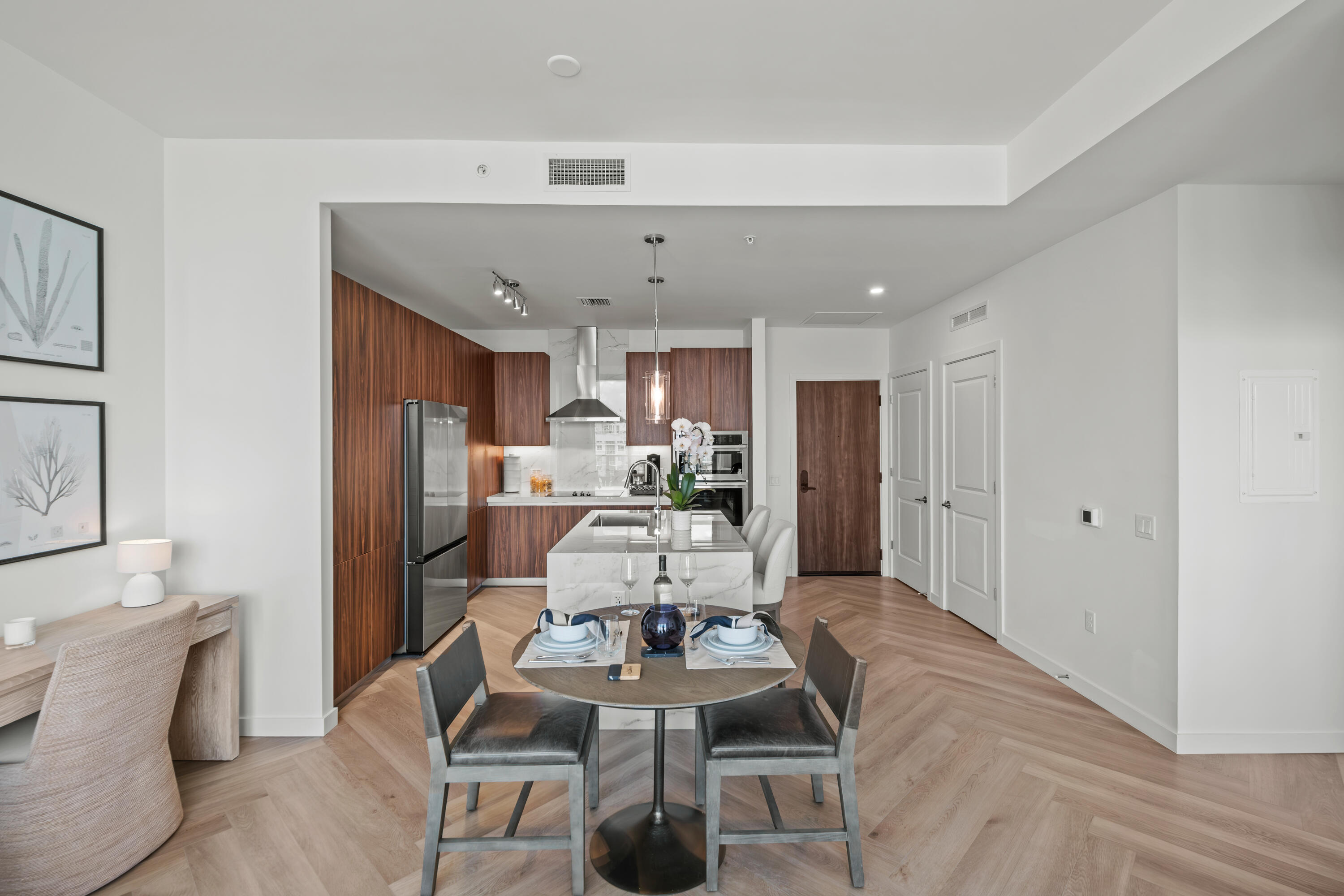 a living room with furniture and a dining table with kitchen view