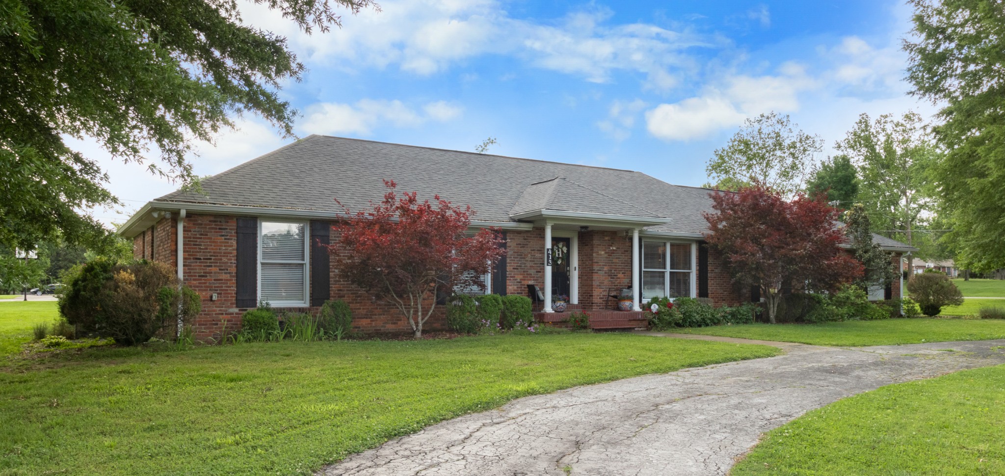 a front view of a house with garden