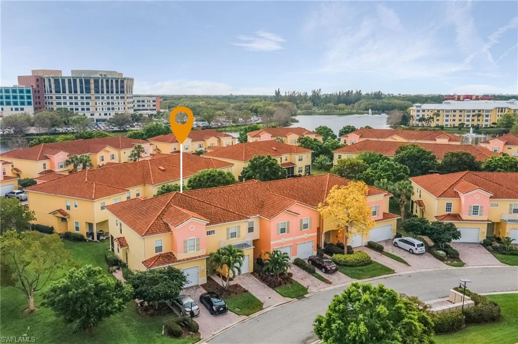 an aerial view of residential houses with outdoor space and city view