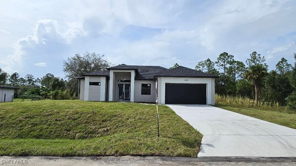 a front view of a house with a yard and garage