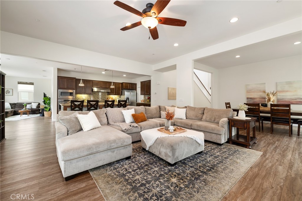 a living room with furniture ceiling fan and a rug