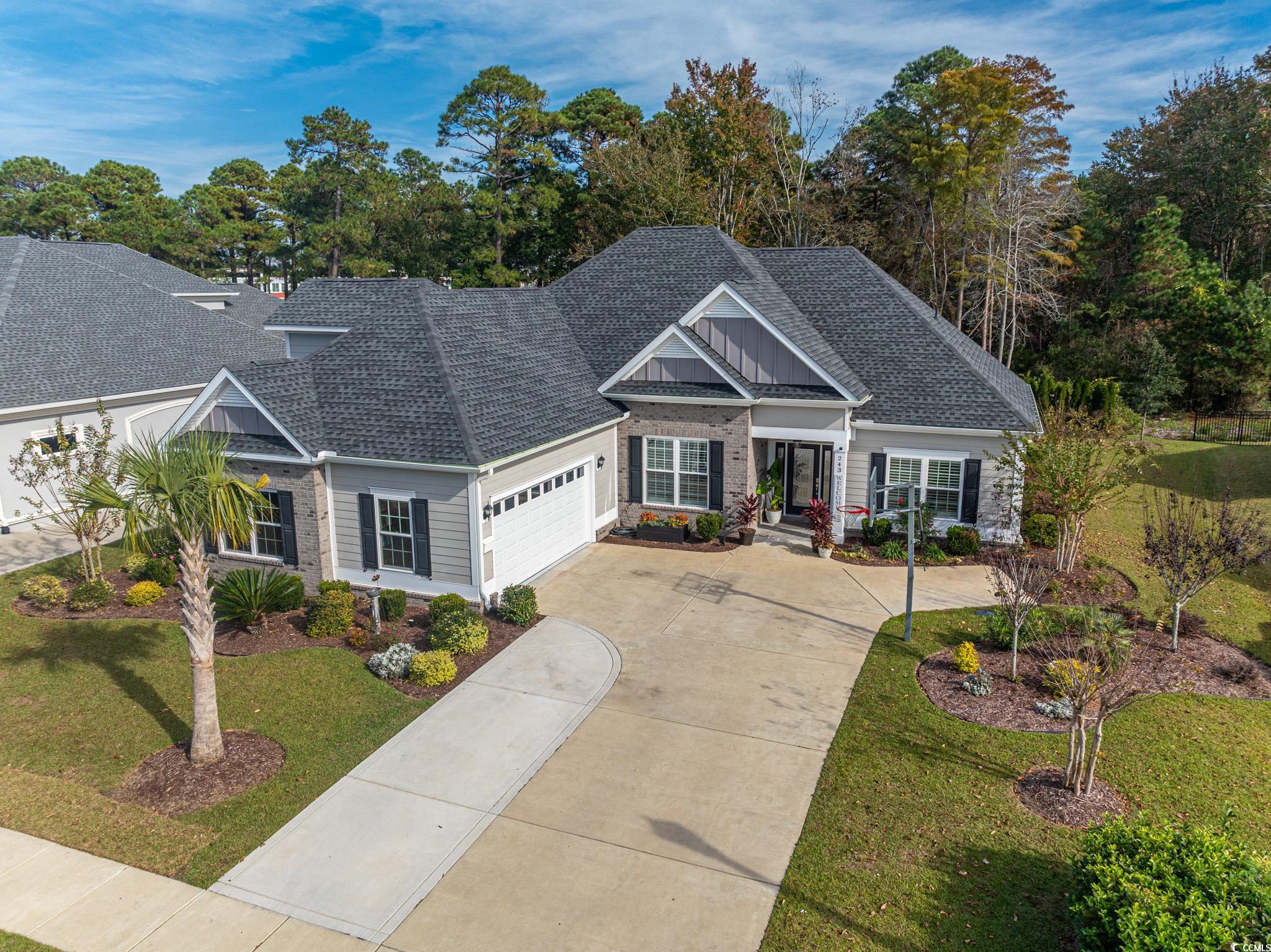 Craftsman house featuring a garage and a front law