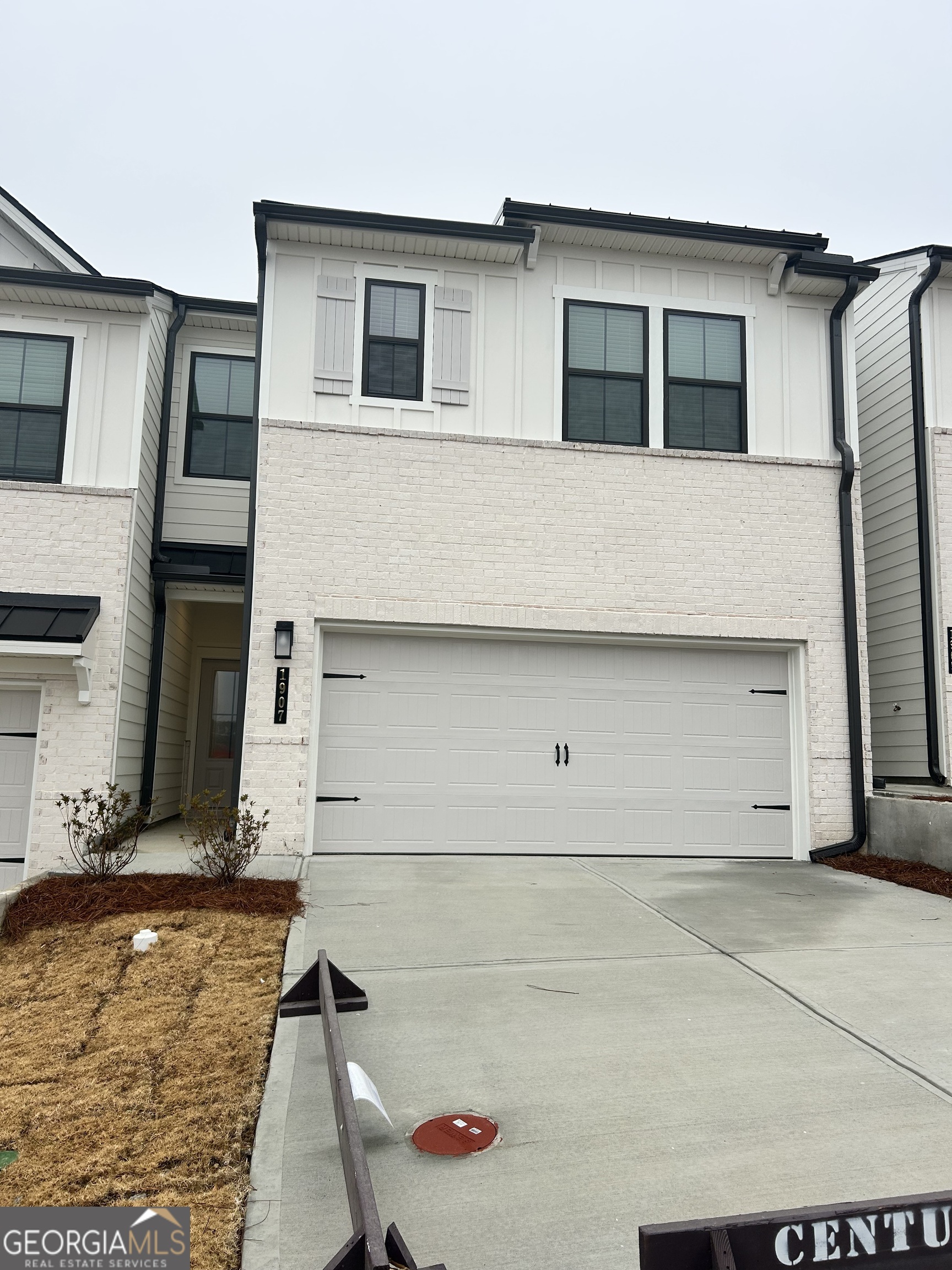 a front view of a house with garage