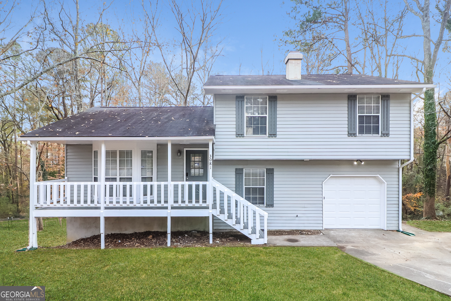 a view of a house with a yard and deck