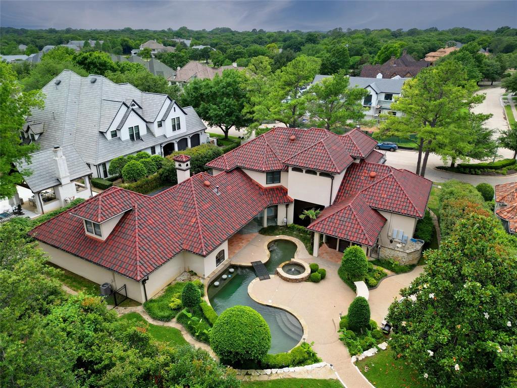 an aerial view of a house with garden space and a street view