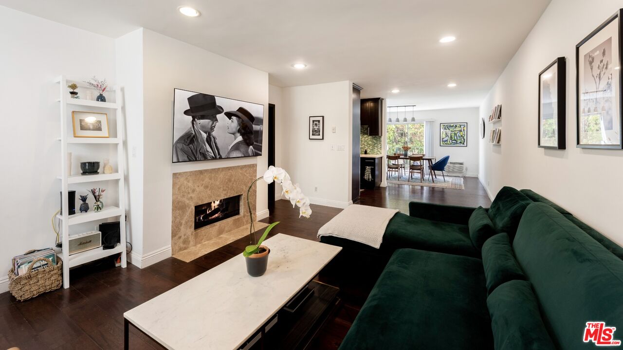 a living room with furniture fireplace and window