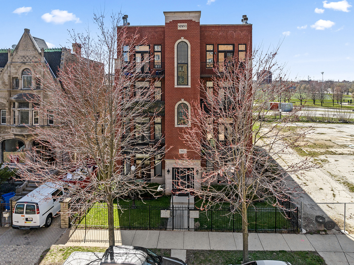 a front view of a residential apartment building with a yard