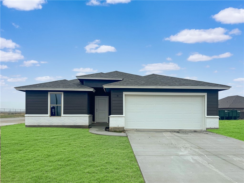 a front view of a house with a garden and yard