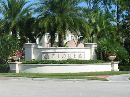 a white house that has tree in front of it