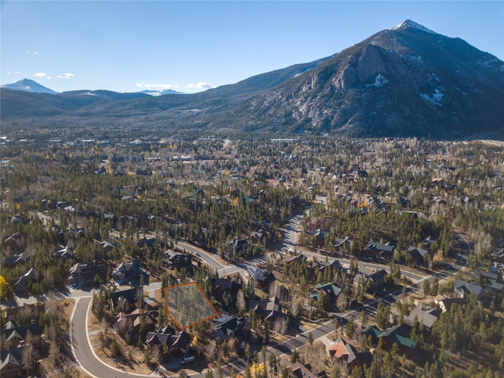 a view of a house with a mountain and a forest