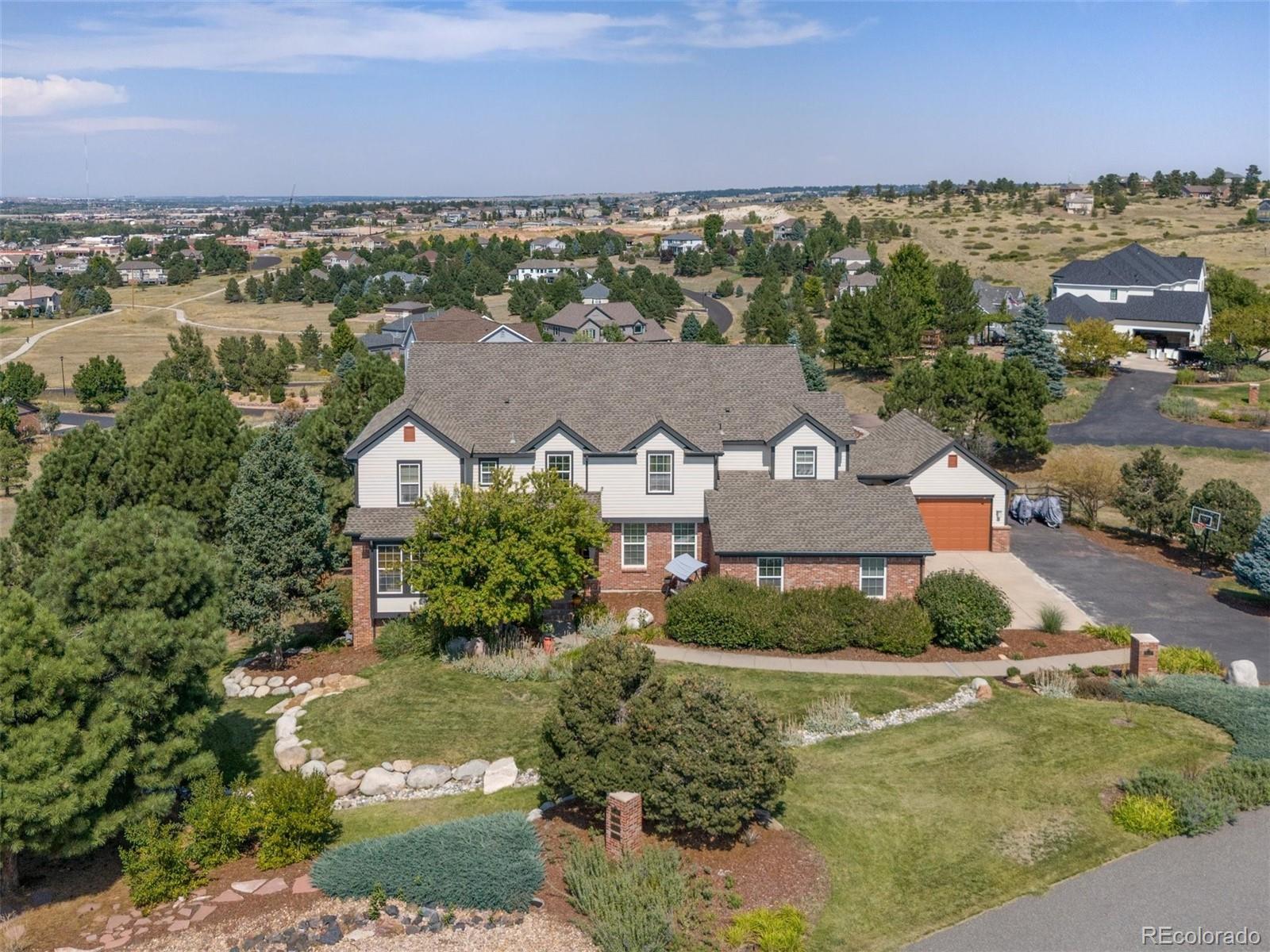 an aerial view of residential houses with outdoor space and a lake view