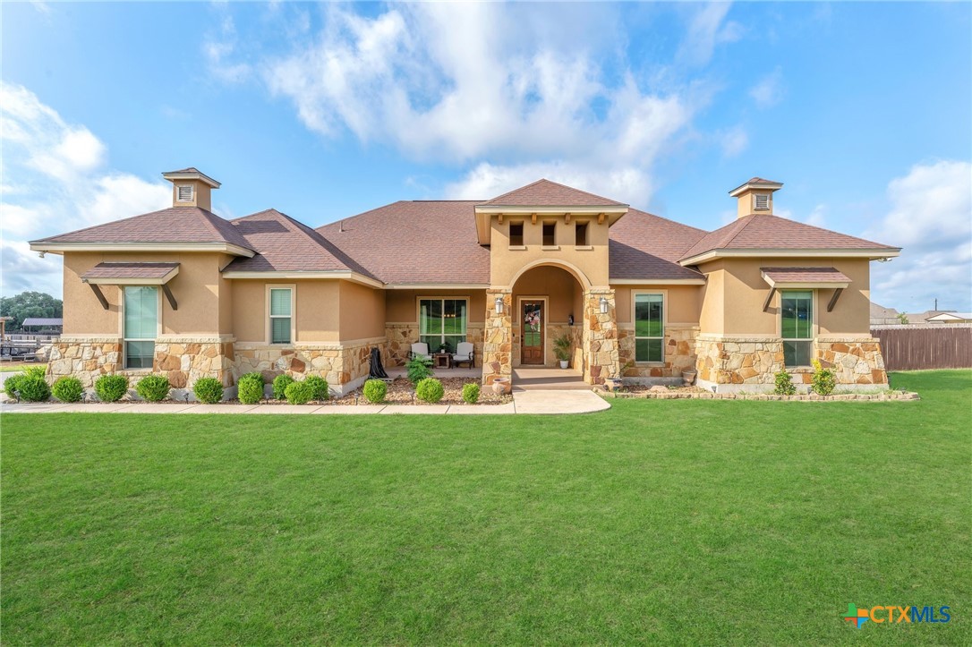 a front view of a house with a garden