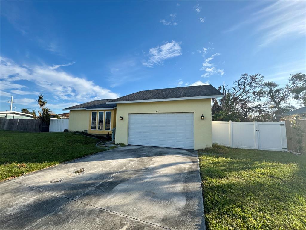 a view of a house with a yard and garage