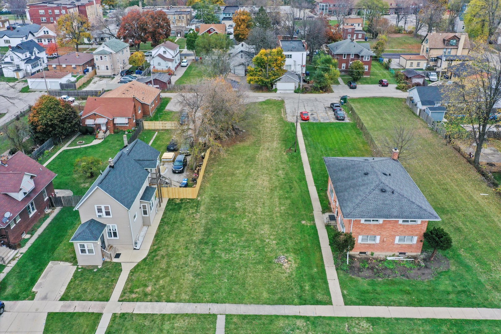 an aerial view of multiple houses with yard