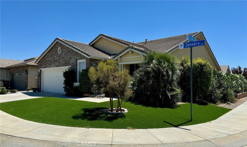 a front view of a house with a garden and yard