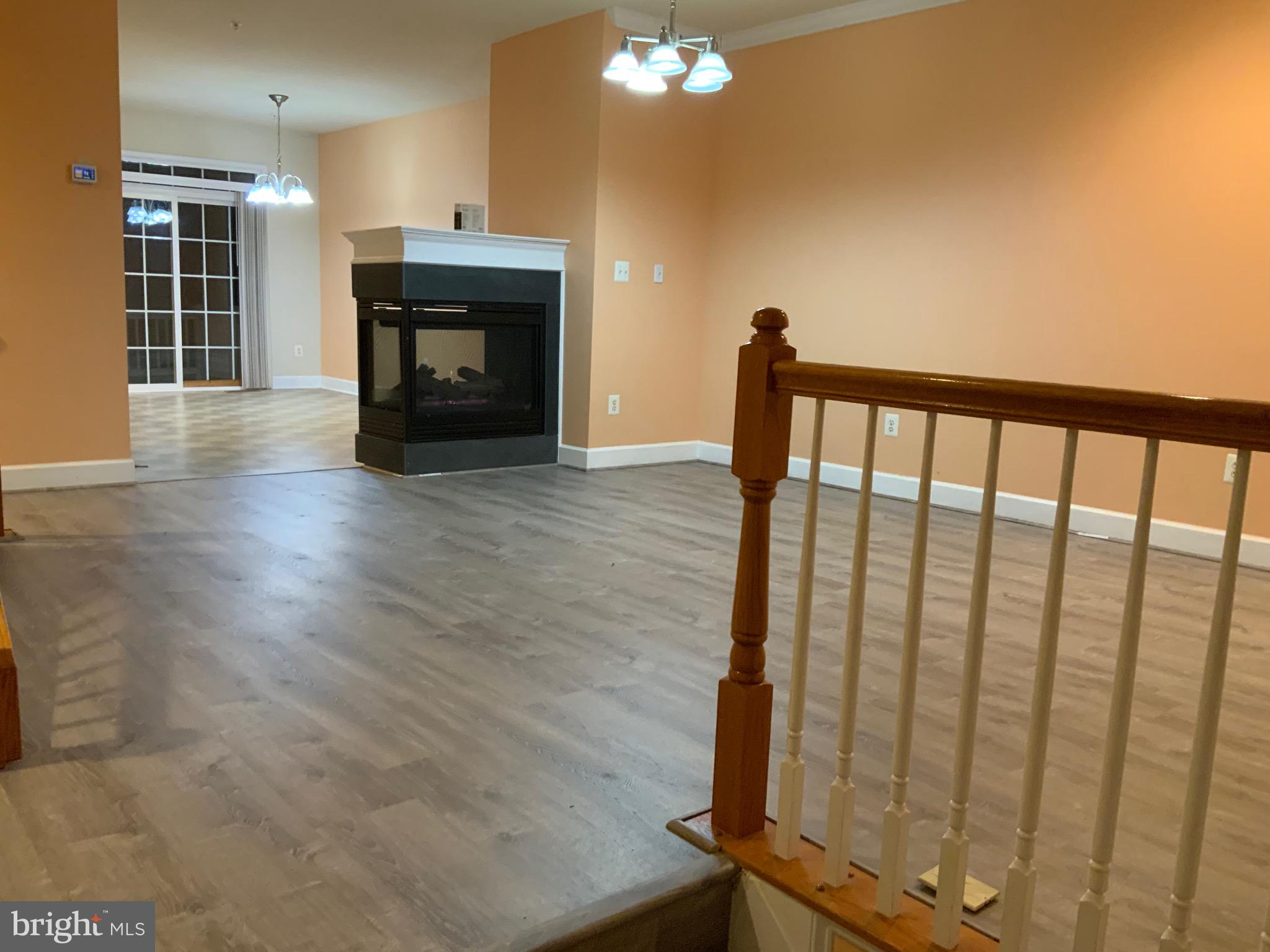 a view of a livingroom with furniture fire place and refrigerator