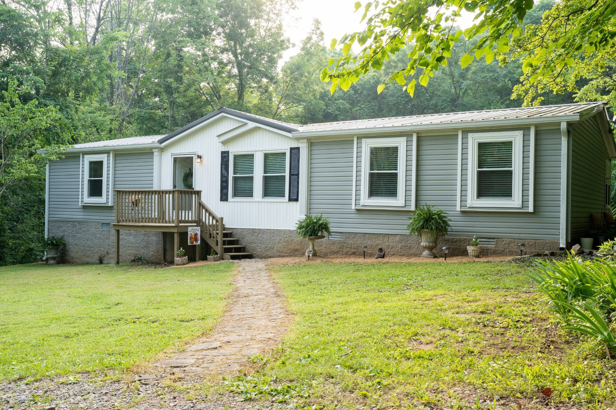 a front view of house with yard and green space