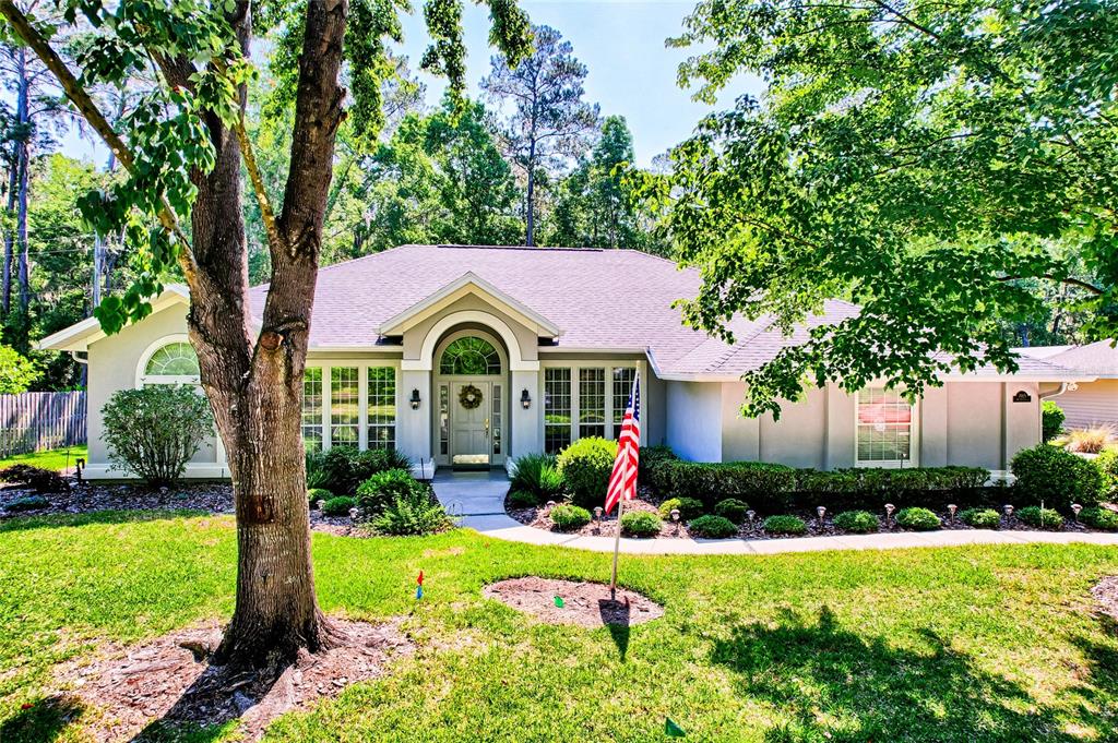 a front view of house with yard and green space