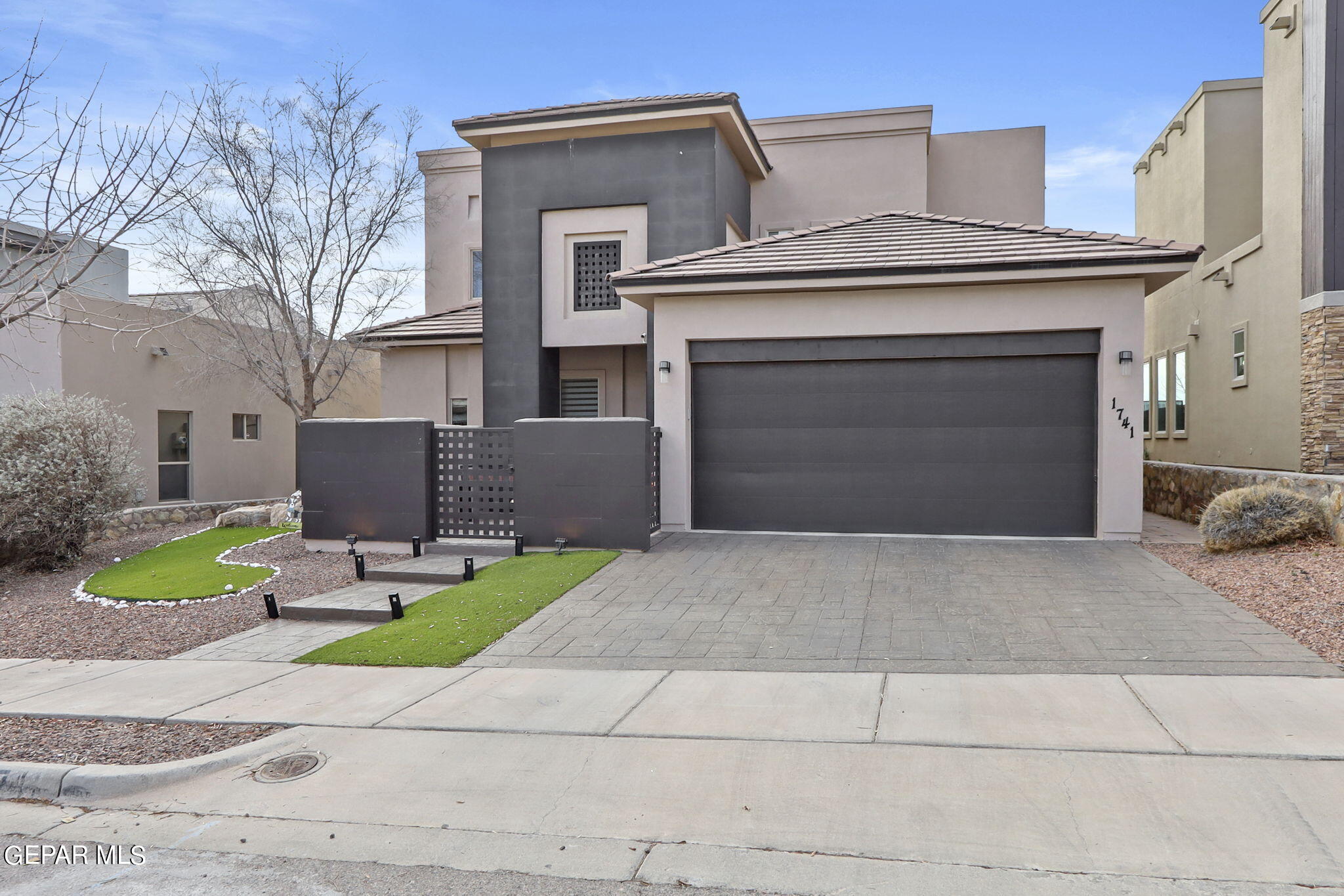 a view of a house with a yard and garage