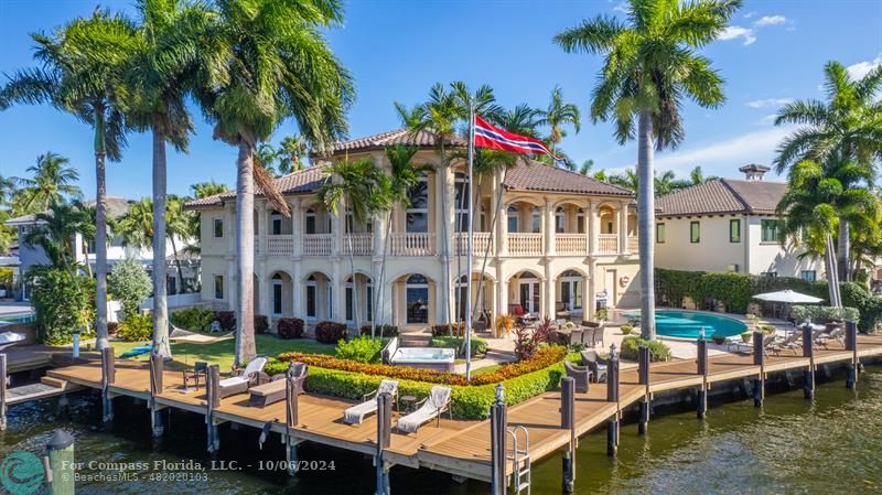 a view of an house with swimming pool and porch with furniture