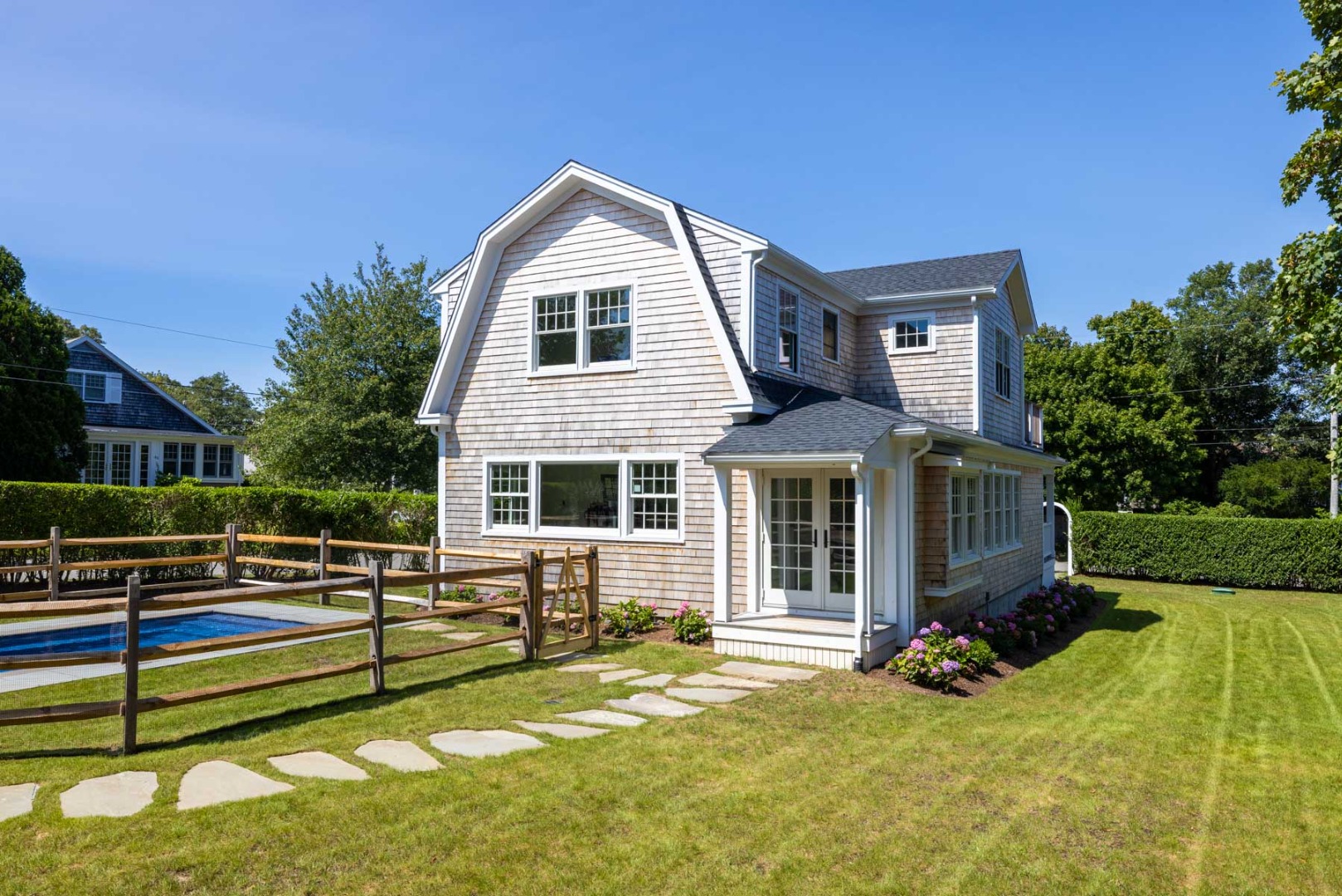 a view of an house with backyard and sitting area