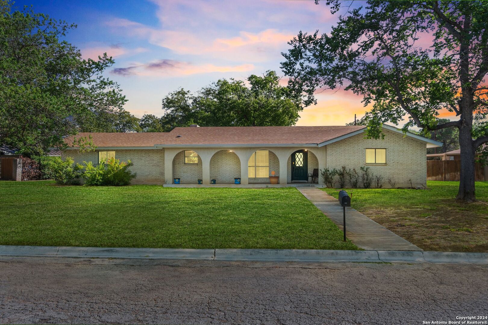 a front view of a house with a garden