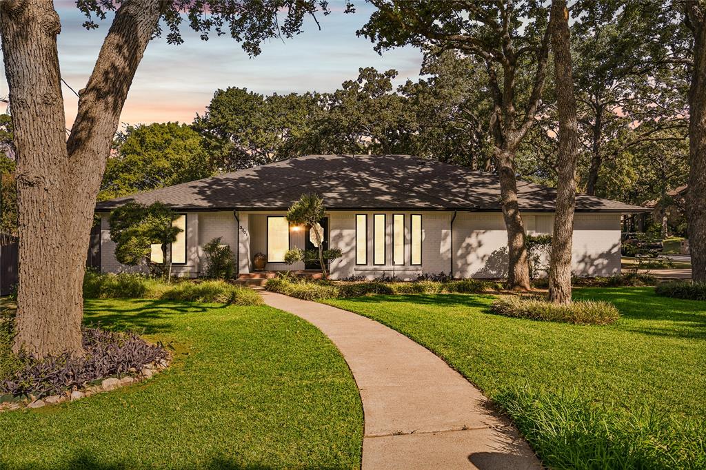 a view of a house with backyard sitting area and garden