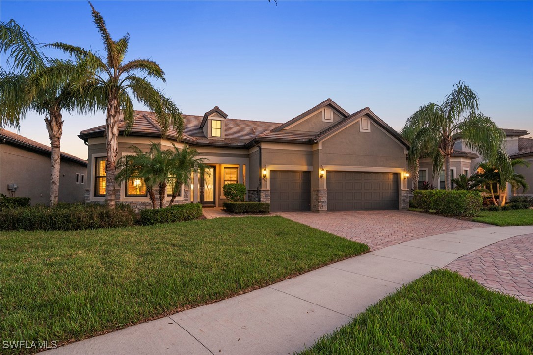 a front view of a house with a garden