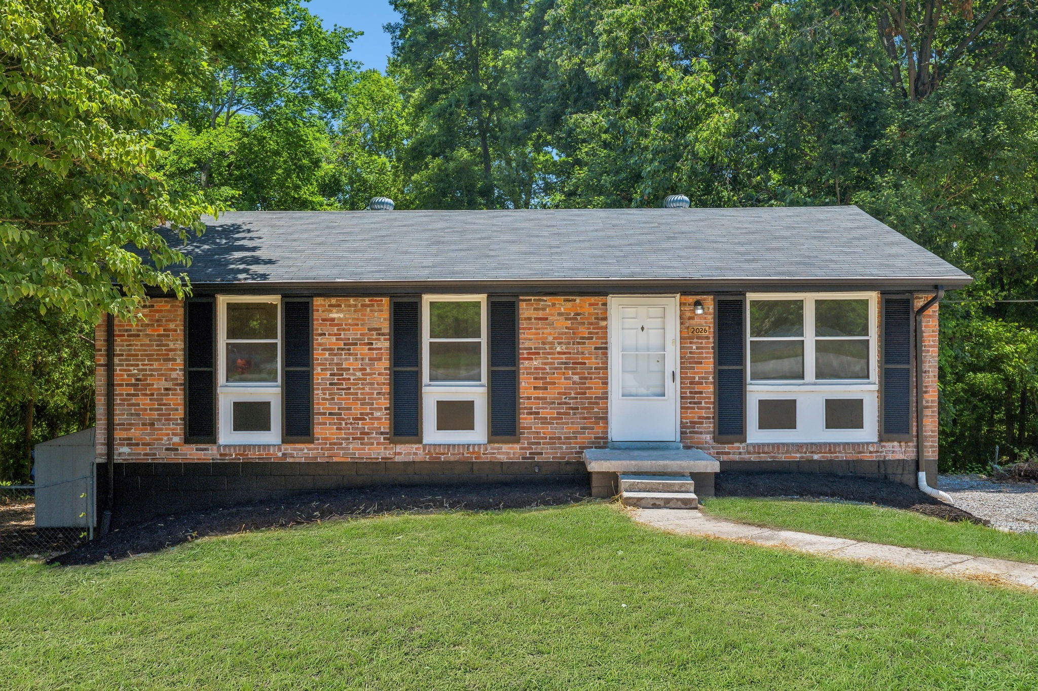 front view of a house with a yard