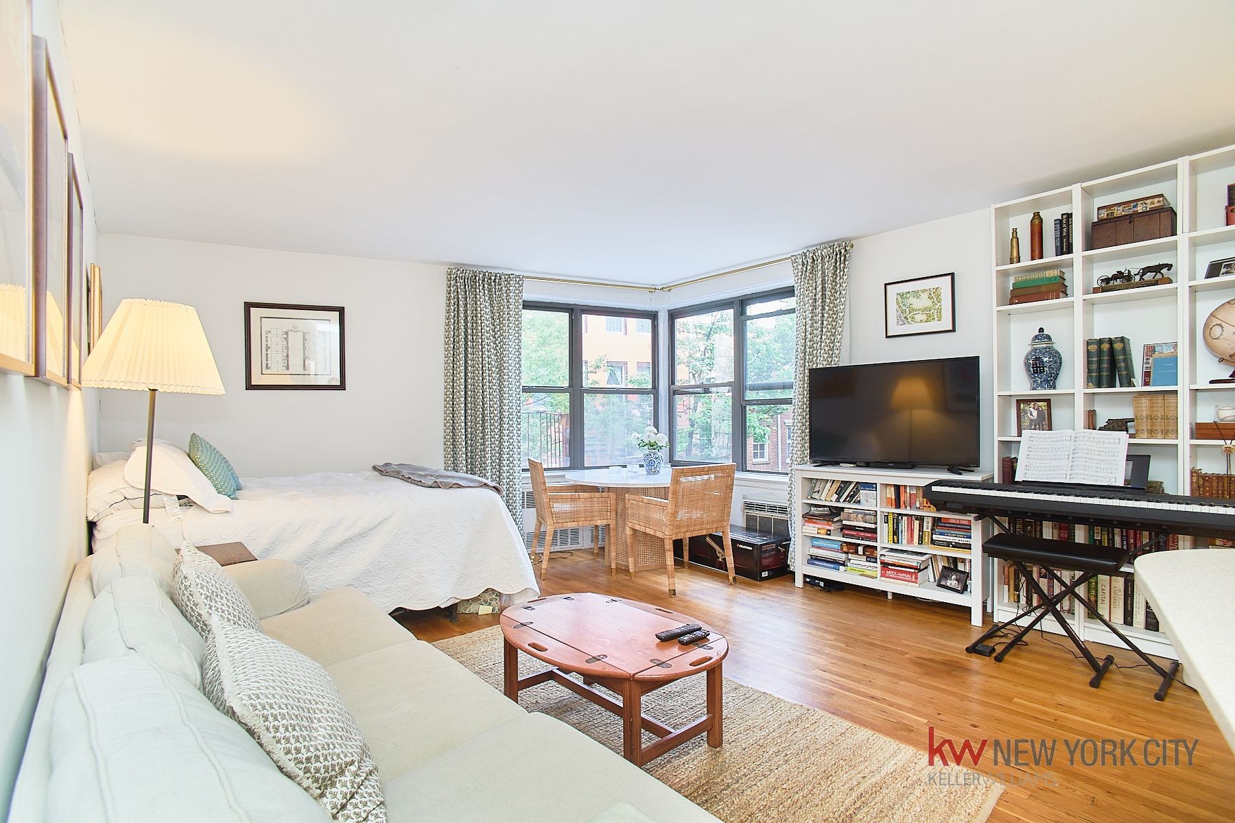 a bedroom with furniture and a flat screen tv