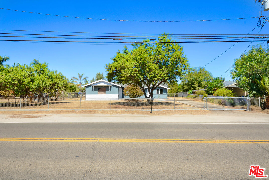 a white building with trees in the background