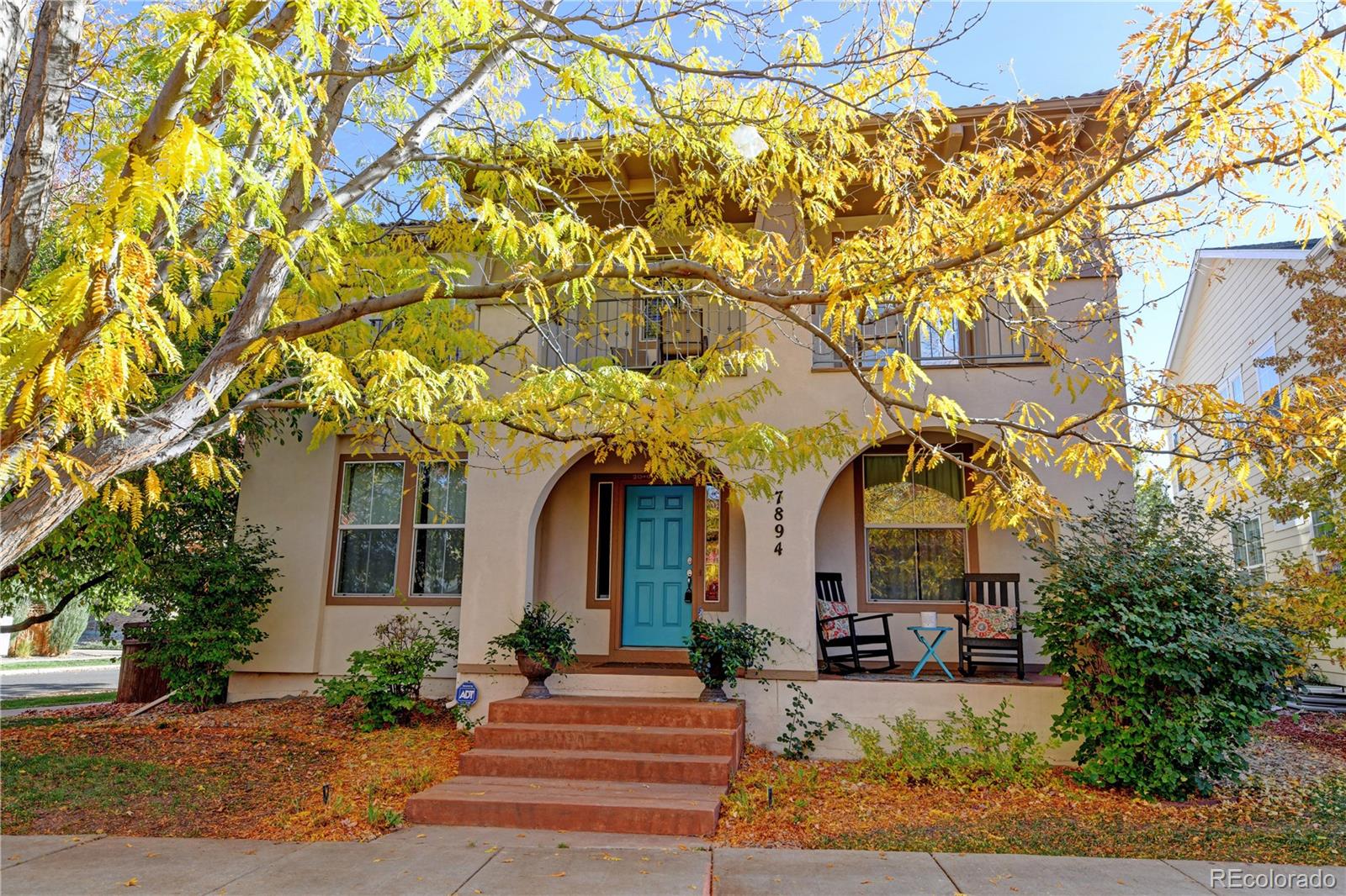 front view of a house with a tree