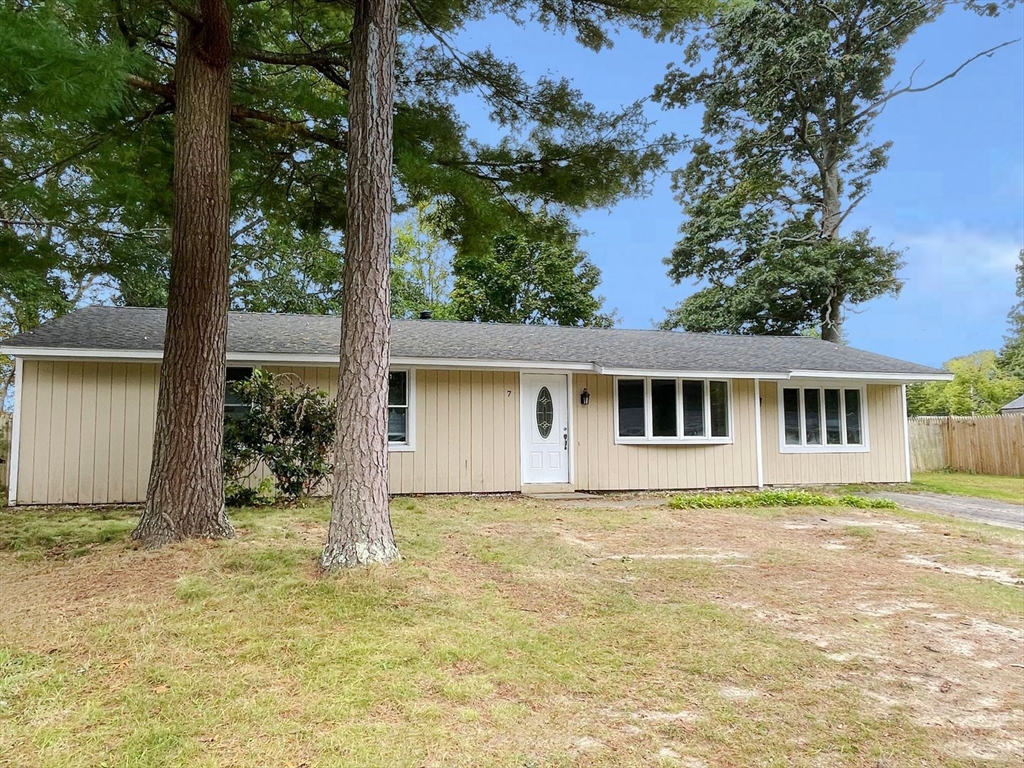 a house that has a tree in front of it