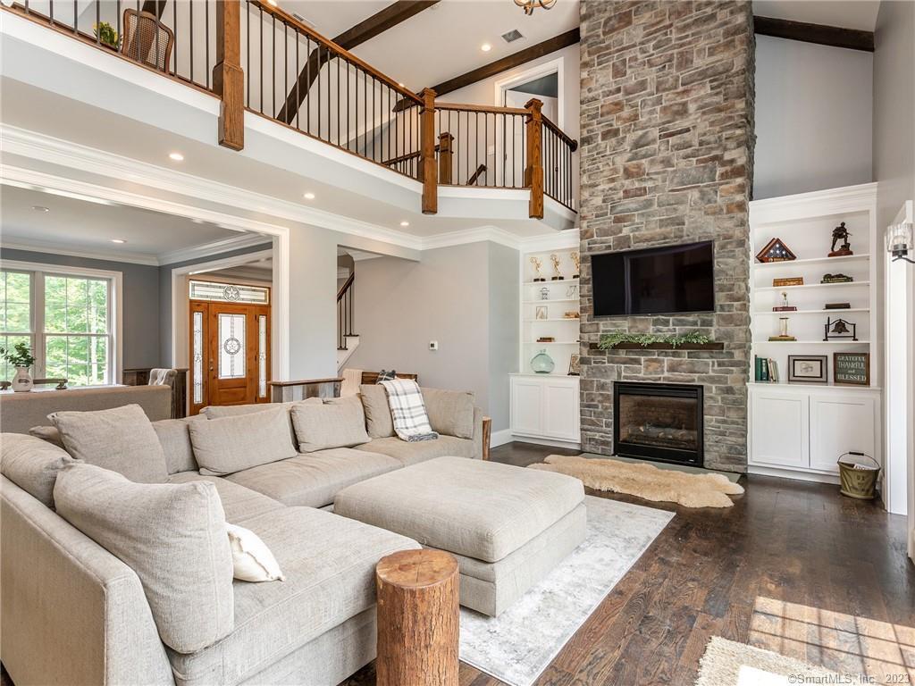 a living room with furniture a fireplace and a flat screen tv