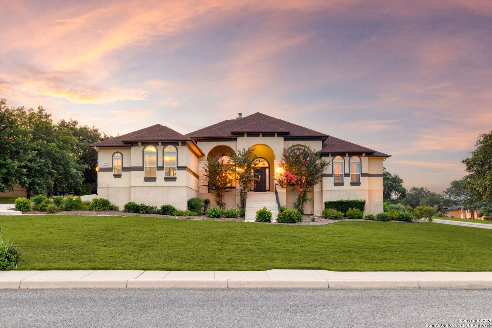 a front view of house with yard and green space