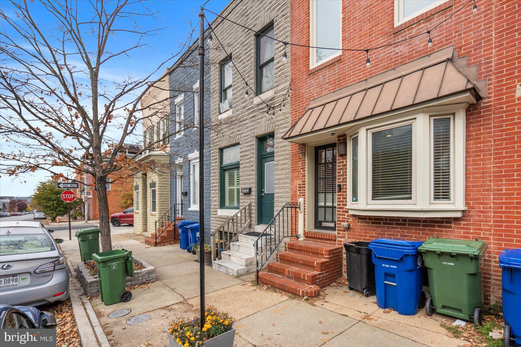 a front view of a brick building with outdoor seating