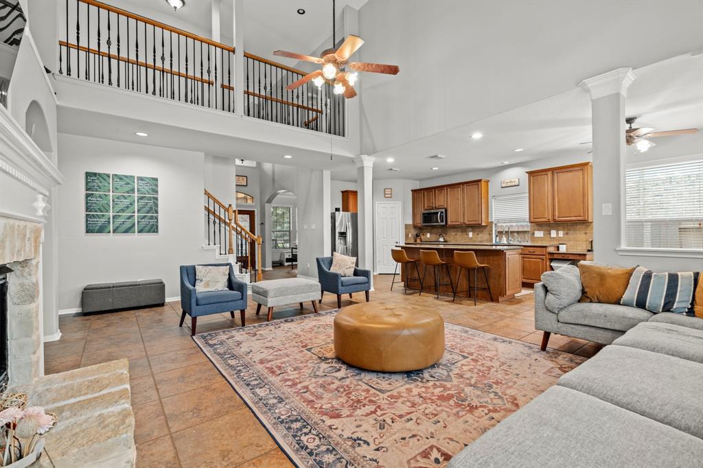 a living room with furniture kitchen view and a chandelier