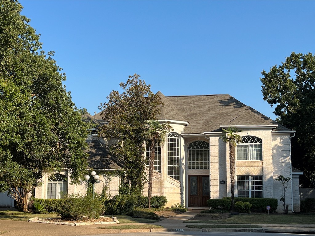 a front view of residential houses with yard