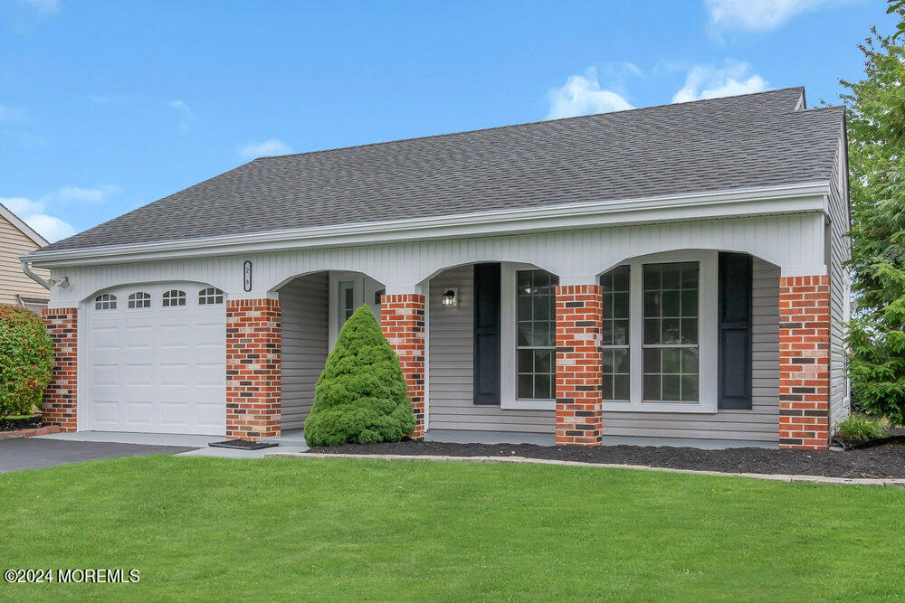 a front view of a house with a garden