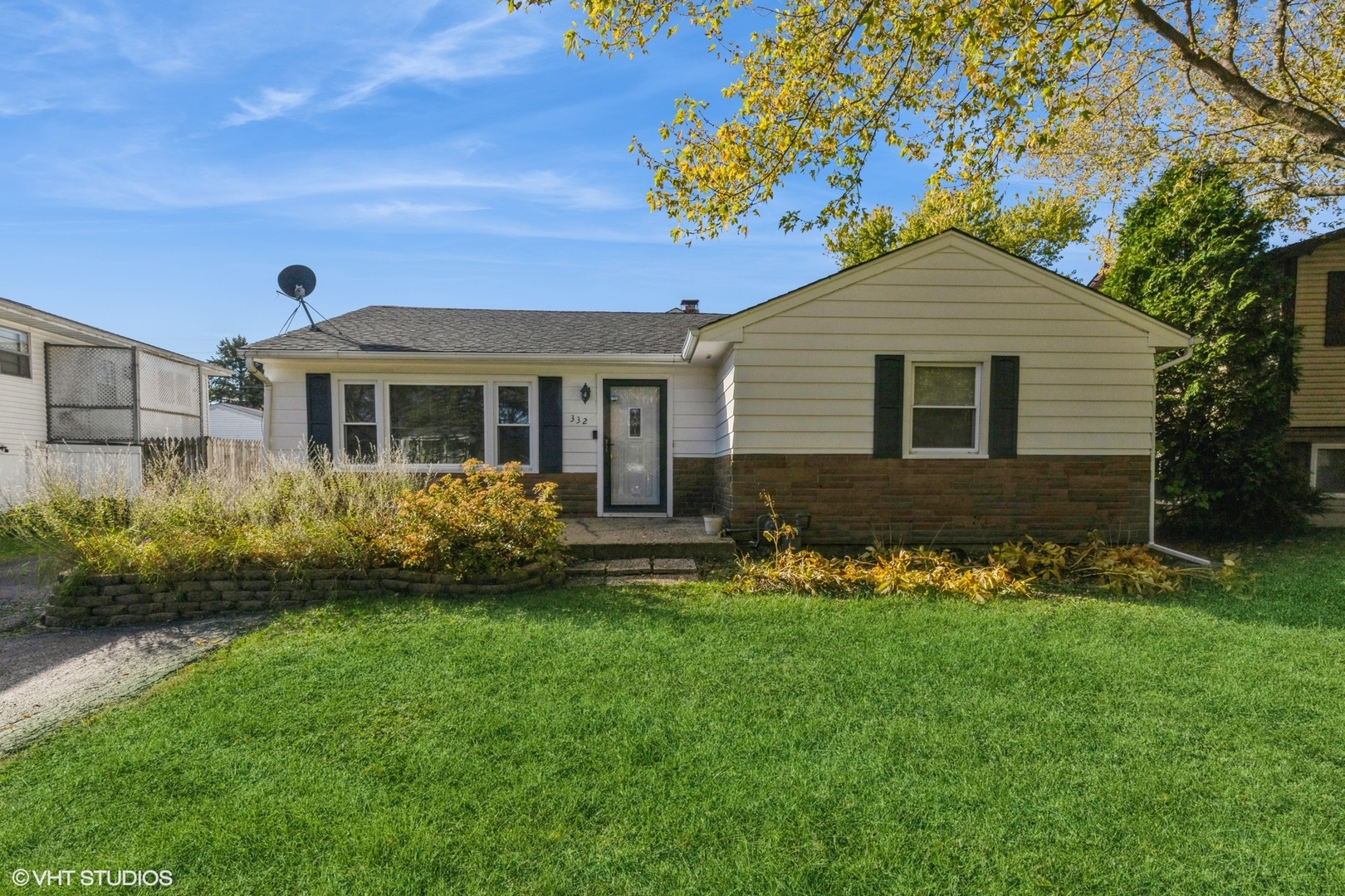 a front view of a house with a yard and porch