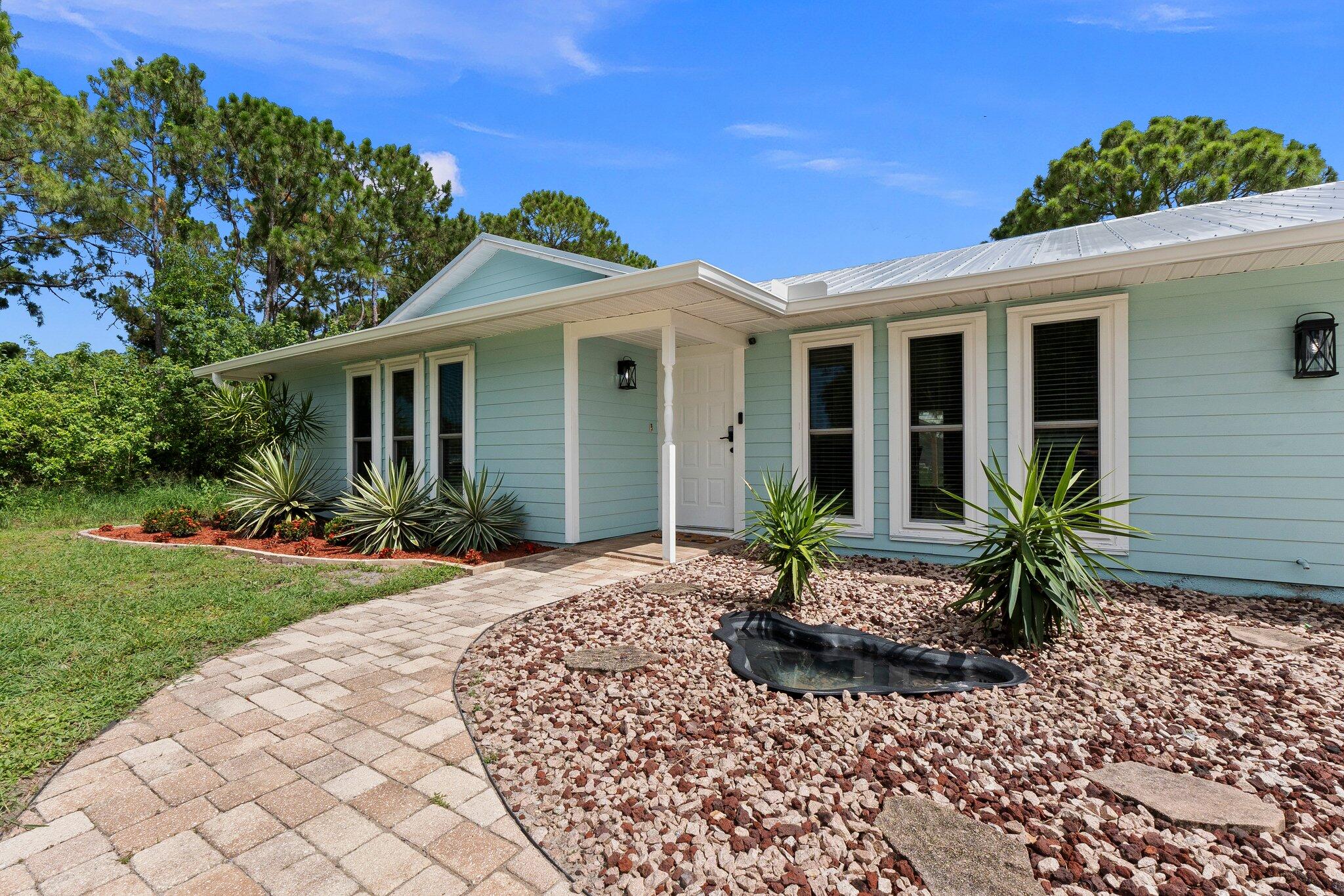 a front view of a house with garden