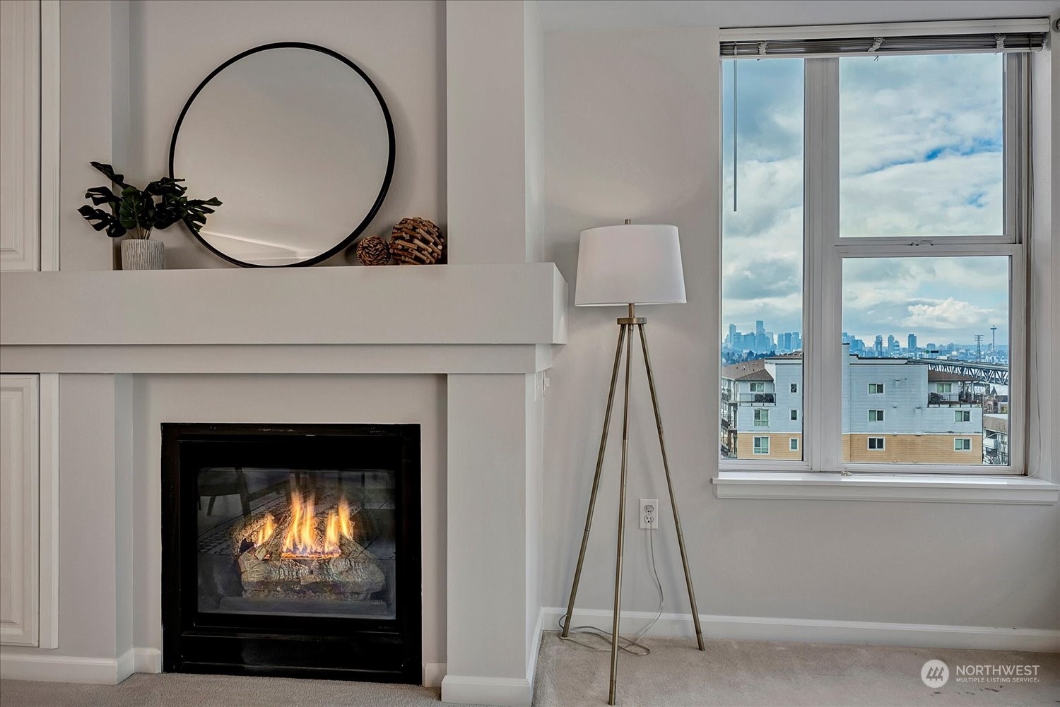 a living room with a fireplace and a floor to ceiling window