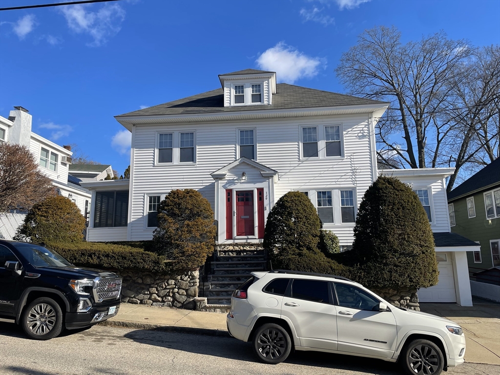 a front view of a house with parking space